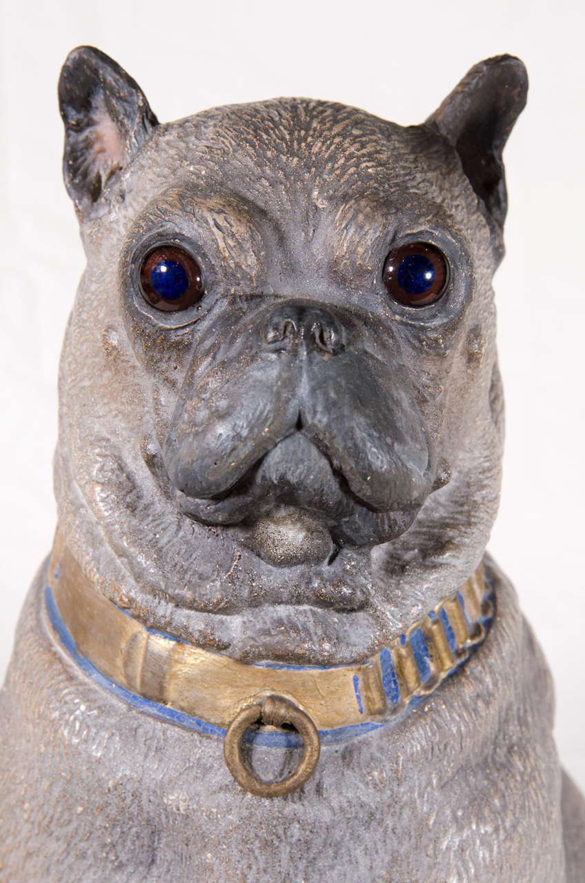 Sitting proudly this Austrian cold-painted terra cotta dog has an engaging face, detailed fur lines, a black painted nose and muzzle and a gold collar inlaid with blue. His glass eyes are a deep brown that make him seem lifelike.