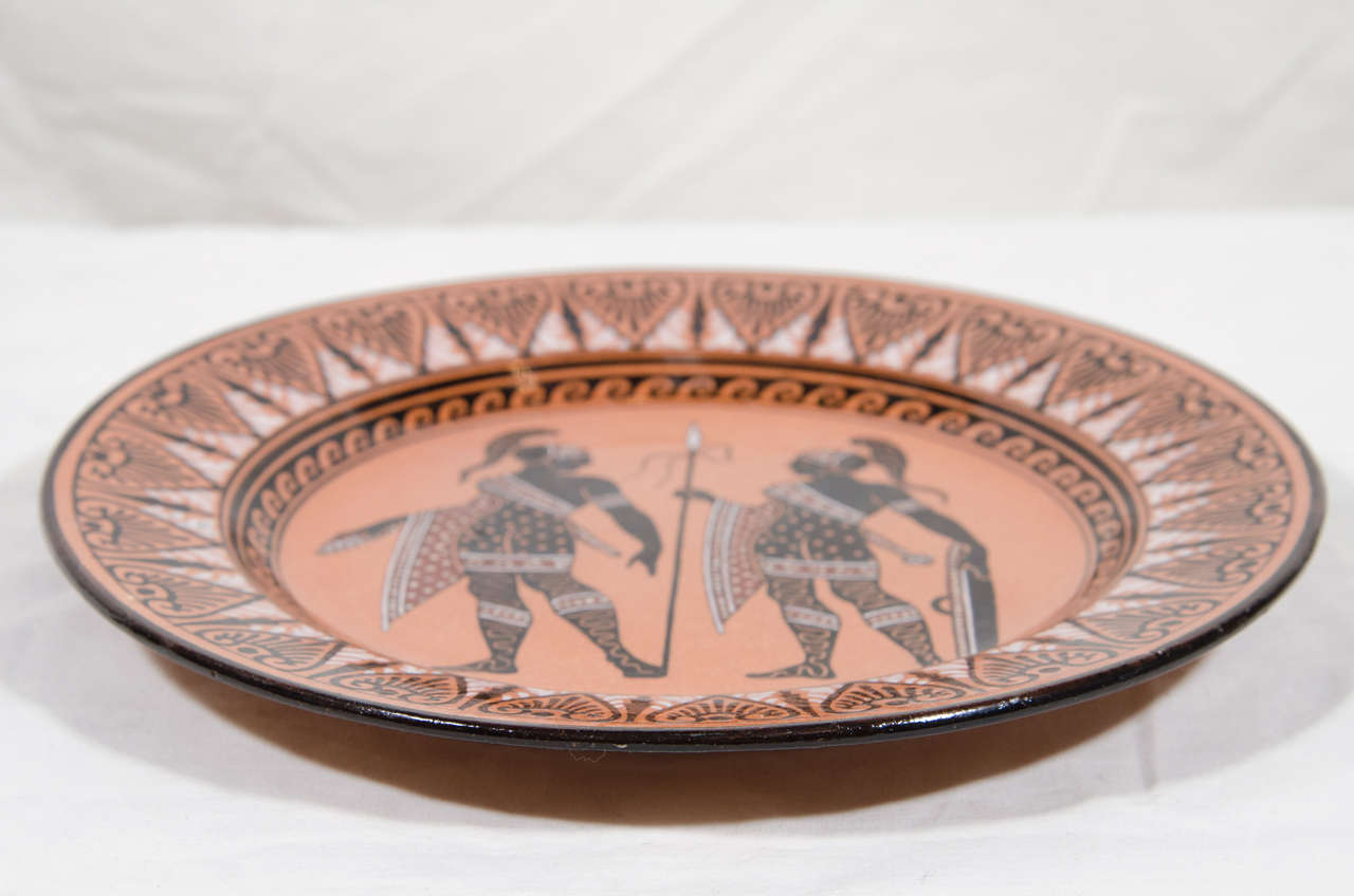 A Giustiniani redware Greek Revival dish decorated in the Etruscan style after the Antique. With classical figures painted in black and red on a terracotta ground all within a geometric border.
Made in the factory of the Giustiniani Family which