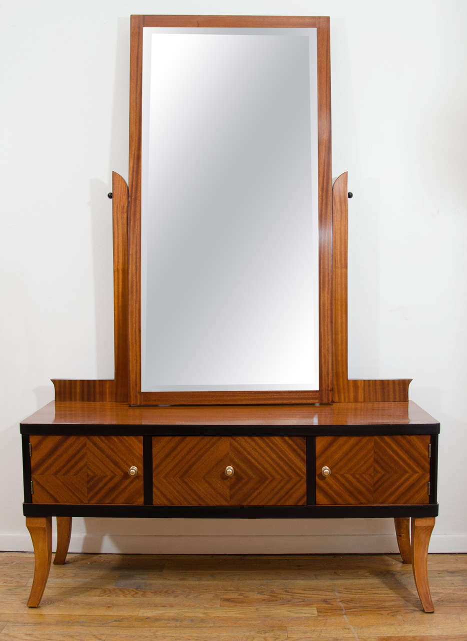 Need a full length mirror? Need more storage? Here is where you keep your lint brush, hair dryer, hair-brush and gels: everything to get you stylishly out the door! The tilting mirror gives the big view above and below, while the parquetry veneered