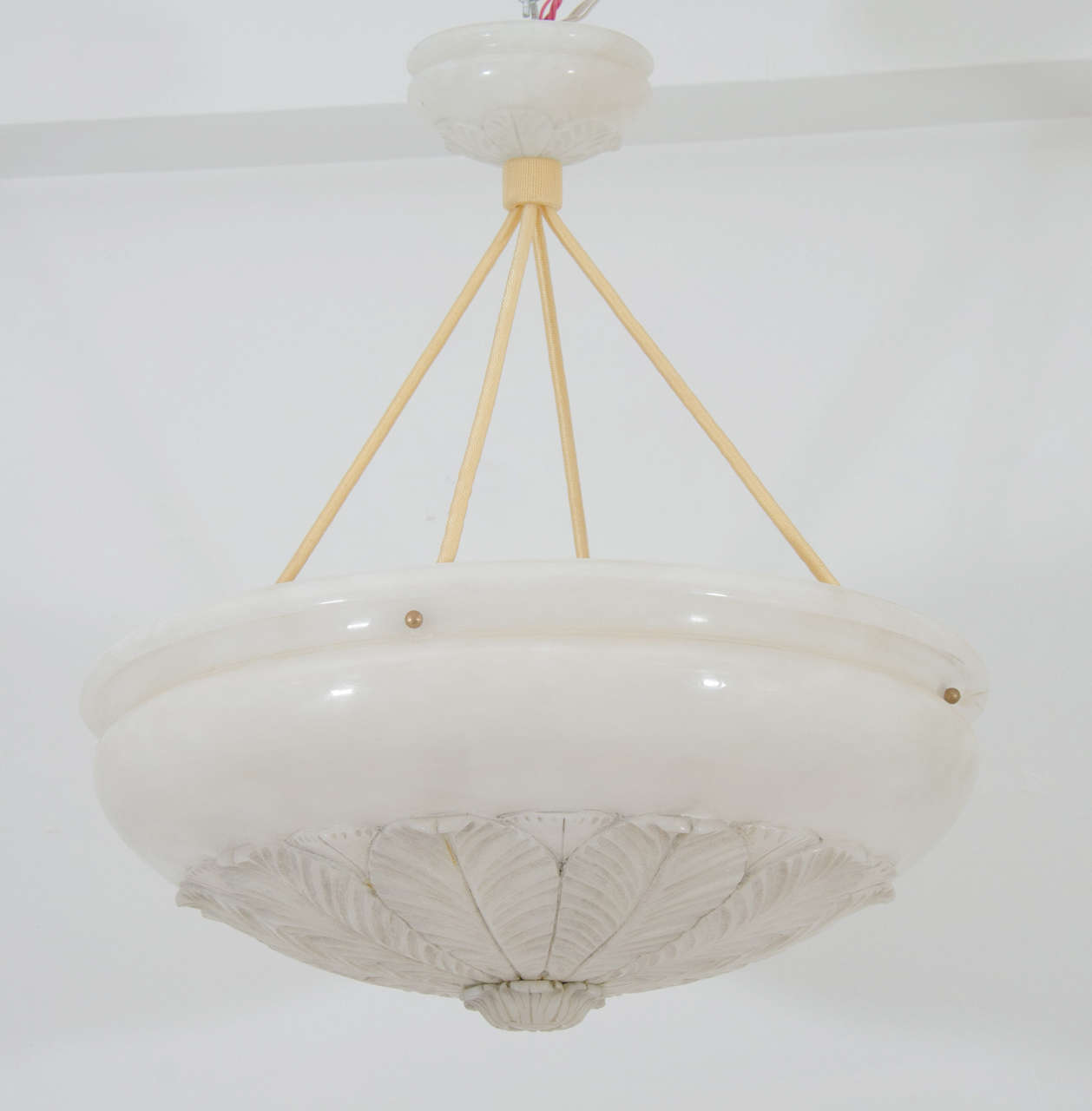 Carved from a single piece of alabaster with faint mineral veining, the piece was carved to reflect the late nineteenth century interiors of older homes retrofitted for electricity when it first came into use.  Recently rewired, and holding four 60