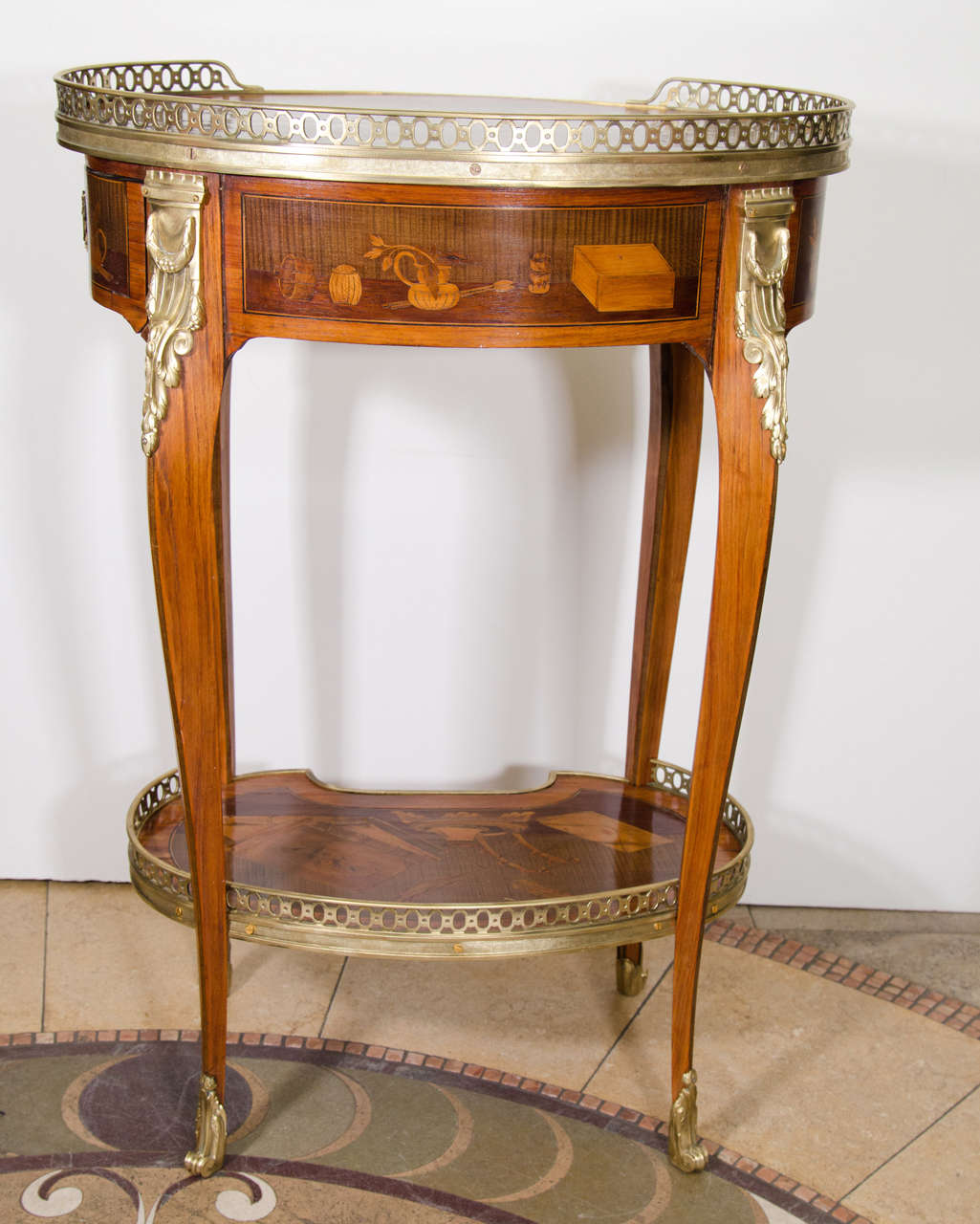 French transitional Louis XV/XVI mahogany oval marquetry side table with ormolu mounts and gallery, and fitted with a slide and a single drawer retaining it's original inkwells.