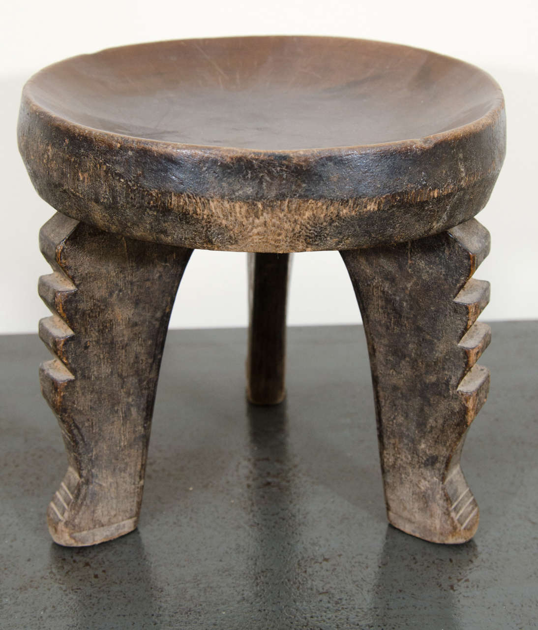 A graphic Hehe stool with three ridged legs and old patina of use.

The Hehe people lived in isolation on a highland in southwestern Tanzania, northeast of Lake Nyasa. With the exception of some pastoralists on the plains and some keeping a