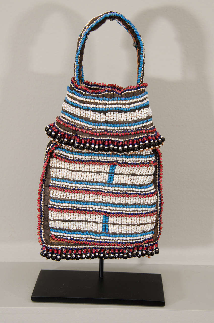 We are proud to offer an outstanding example of an early beaded tobacco bag.

Dating to the 19th century, this beautiful example is made of European glass (Venetian) beads, textile and sinew. The Mfengu, Thembu and Xhosa all used tobacco bags.