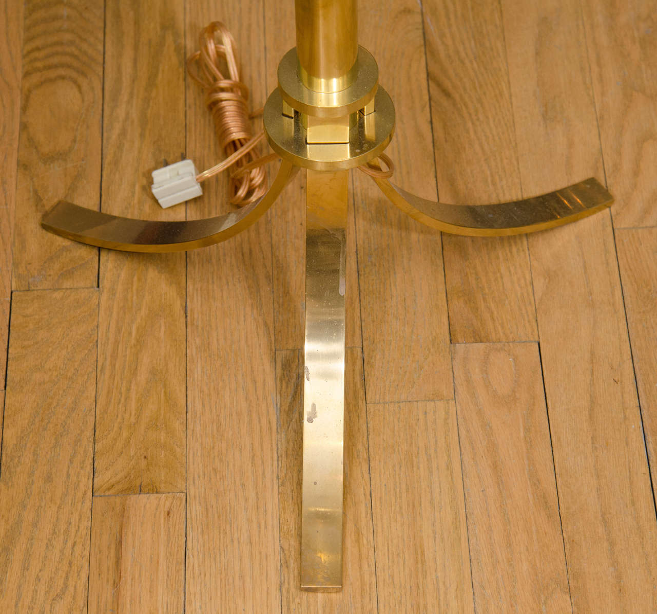 Single brass tripod floor lamp with spherical detail.