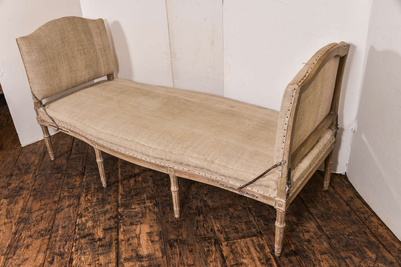 Stunning Swedish Gustavian period daybed in original paint, the piece is in antique linen.  Could float in a room, carved on both sides and also has the ability to fold  down entirely, a real beauty!
