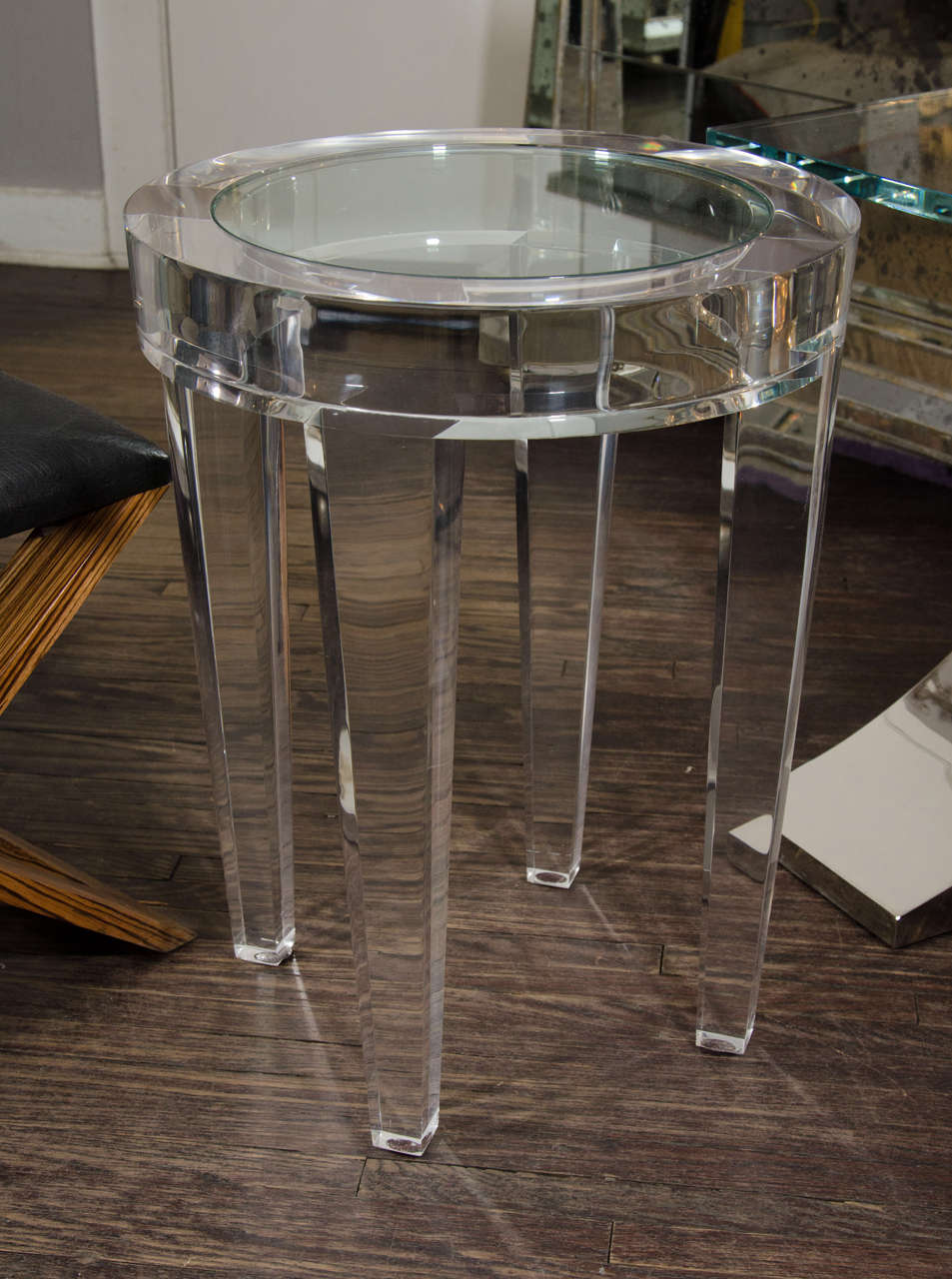 Round acrylic occasional table with glass inset.