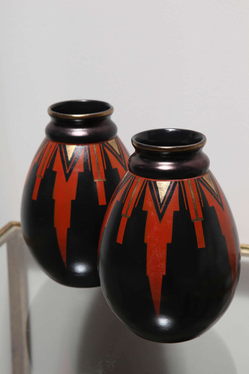 Faience vases marked with the Faiencerie de Saint Ghislain stamp. They are made in style 1808 which is characterized by simple geometric motifs. Designed by Emile Lombart.