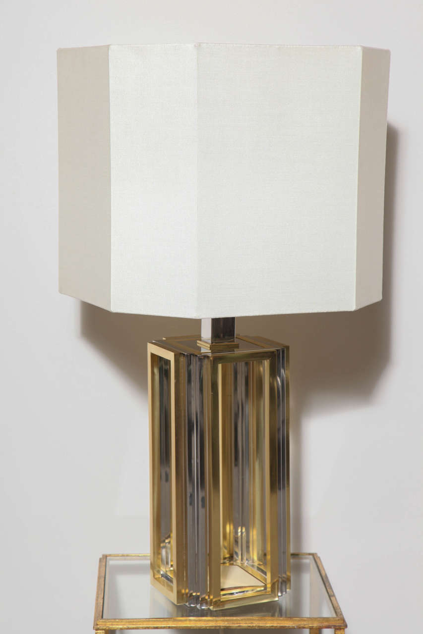 A pair of silvered and brass table lamps by Romeo Rega. Three way lighting. Original ivory silk octagonal shades.