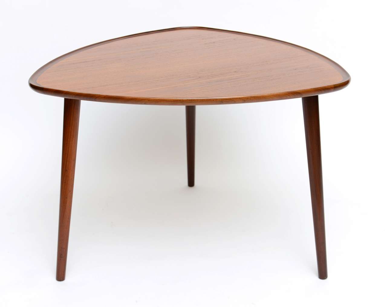 >>>SOLD......Wonderful warm teak and rosewood highlight this table exhibiting beautiful symmetry in the soft triangular form, outstanding cabinetry, artistry and quality from Denmark channeling Finn Juhl. Rising on three slanted solid teak tapering
