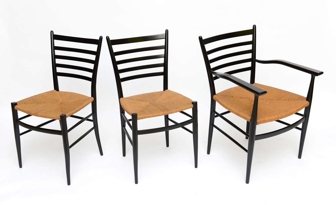 SOLD Gorgeous set of modern Chiavari dining chairs from the studio workshop of Figli di Sanguineti in black lacquered finely shaped wood with woven seats.  With two arm chairs and four side chairs.  The arms are a wonderful design.   The set quite