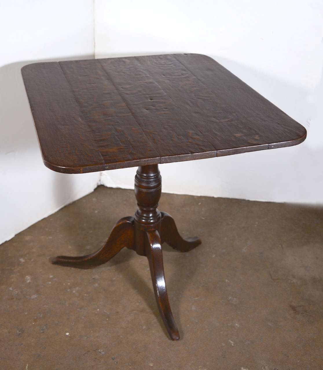 19th century English oak rectangular tilt-top table on a turned base with tripod legs. Can be tilted up with original hardware.