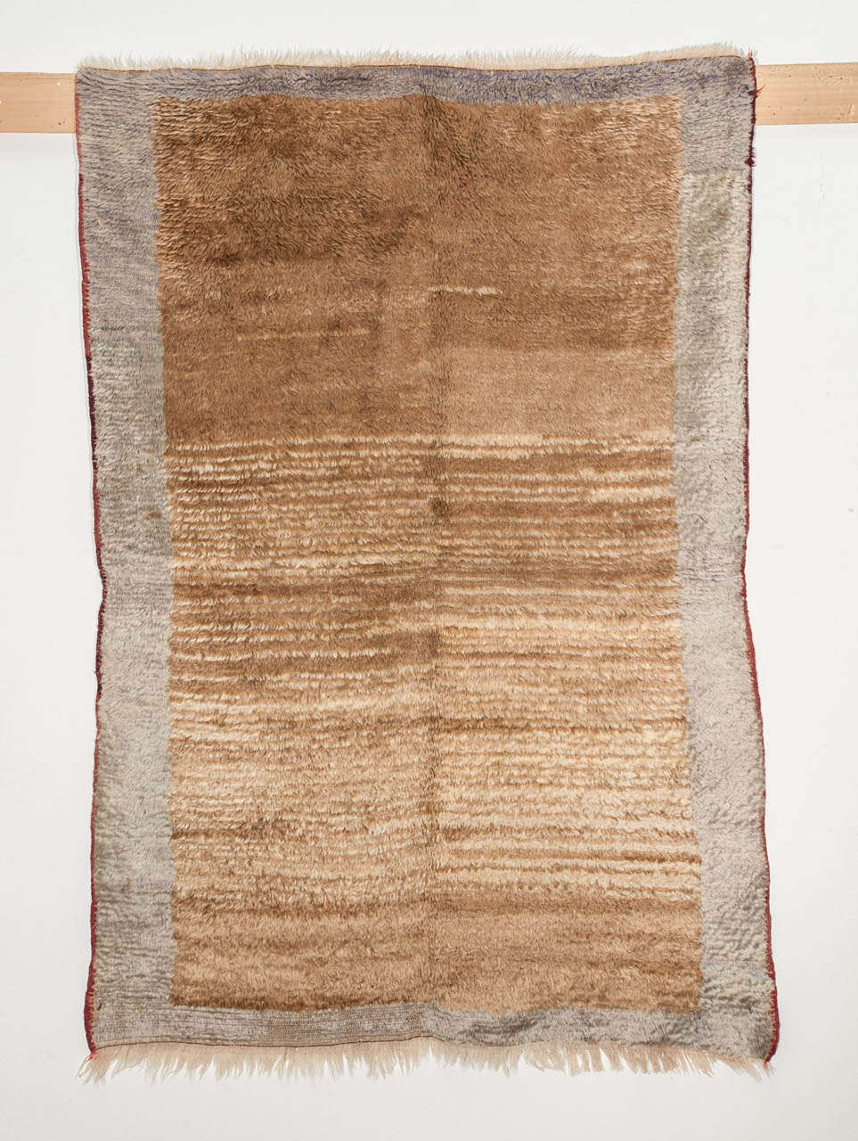 A rare and early Tulu woven using the finest Angora wool, resulting in a finely woven rug with a silky texture and a blanket-like handle.
Examples of this type represent the pinnacle of the Primitive pile weaving tradition, and were woven by the