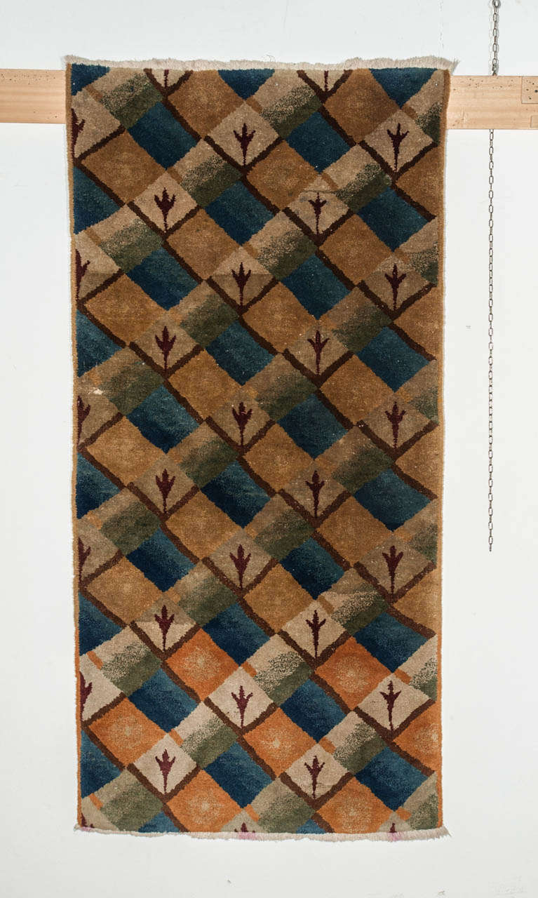 From the large output of Chinese carpets from Tianjin during the 1930's, only a very few are decorated by geometric patterns typical of the Art Deco period. Some of these extremely rare pieces are known to have been designed by artists such as Betty