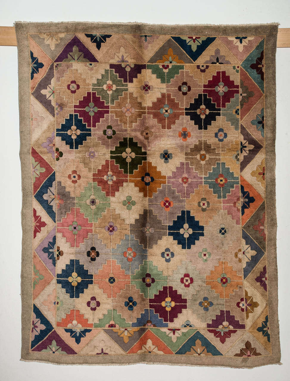 An unusual Chinese carpet decorated by an allover arrangement of polychrome tiles, a pattern which first appears on 17th century Chinese weavings of the Qing Dynasty. The palette as well as the type of weaving is characteristic of the Chinese