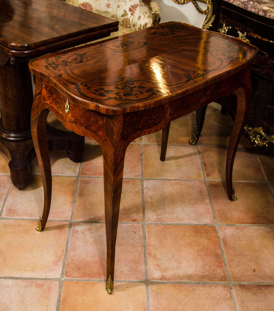 A Fine Louis XV marquetry inlaid kidney form writing table with bronze mounts.