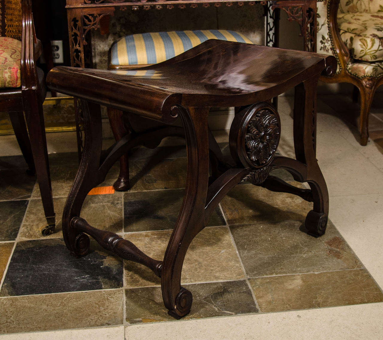 A finely carved George II (Thomas Chippendale) style saddle seat stool with carved rosette.