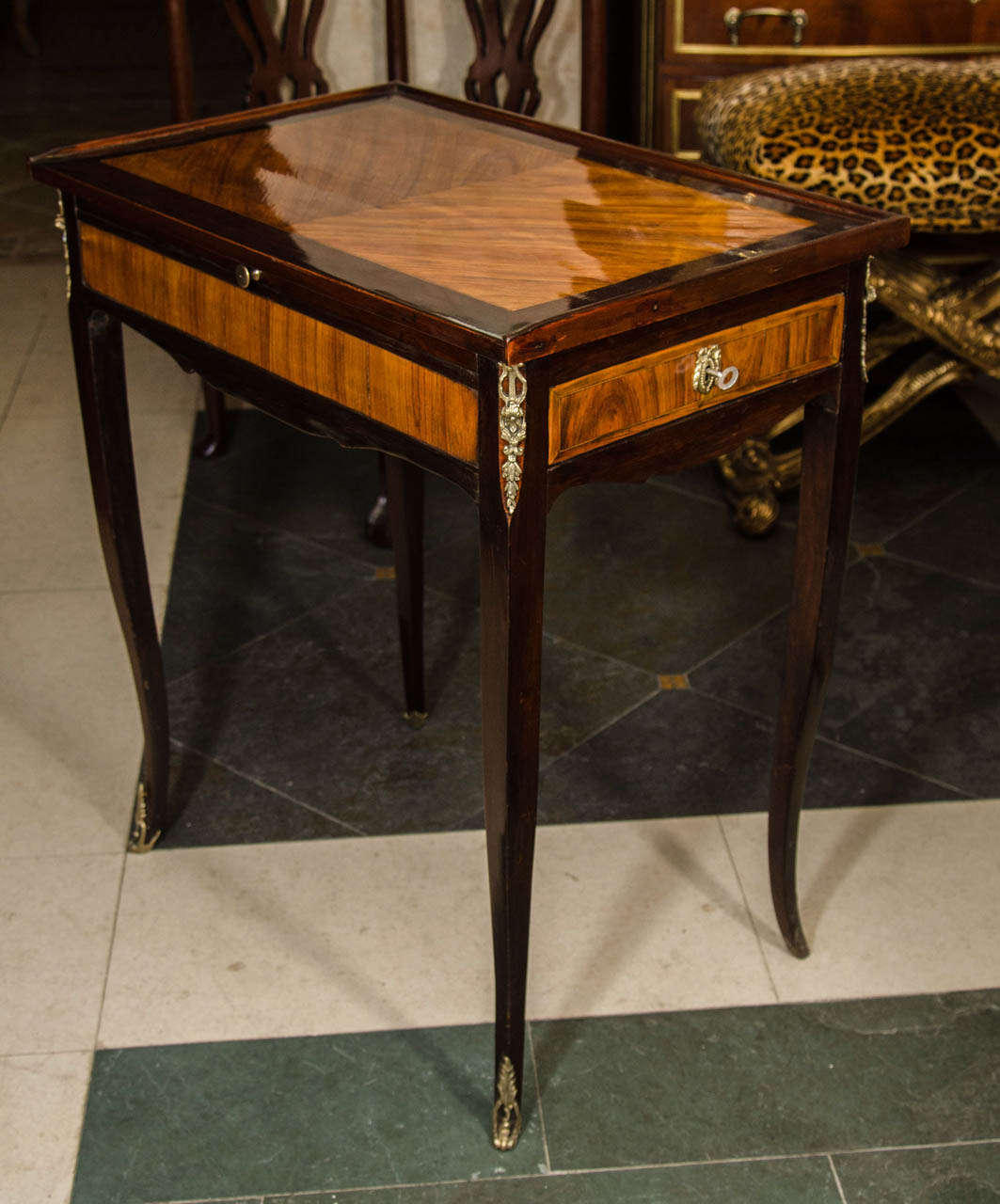 A fine French Louis XV- XVI transitional inlaid and crossbanded table a ecrire with side drawer and large leather top writing slide.