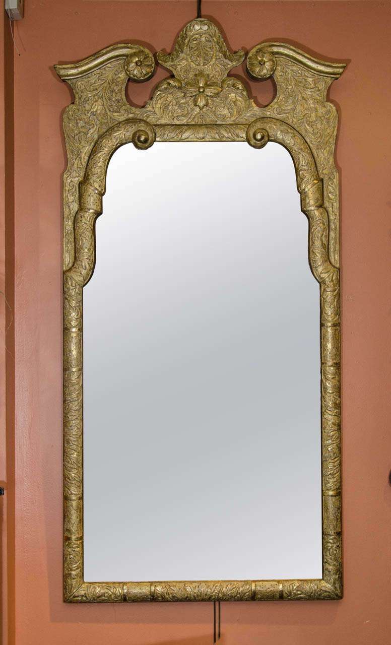 A fine George I carved and incised gilt wood mirror.