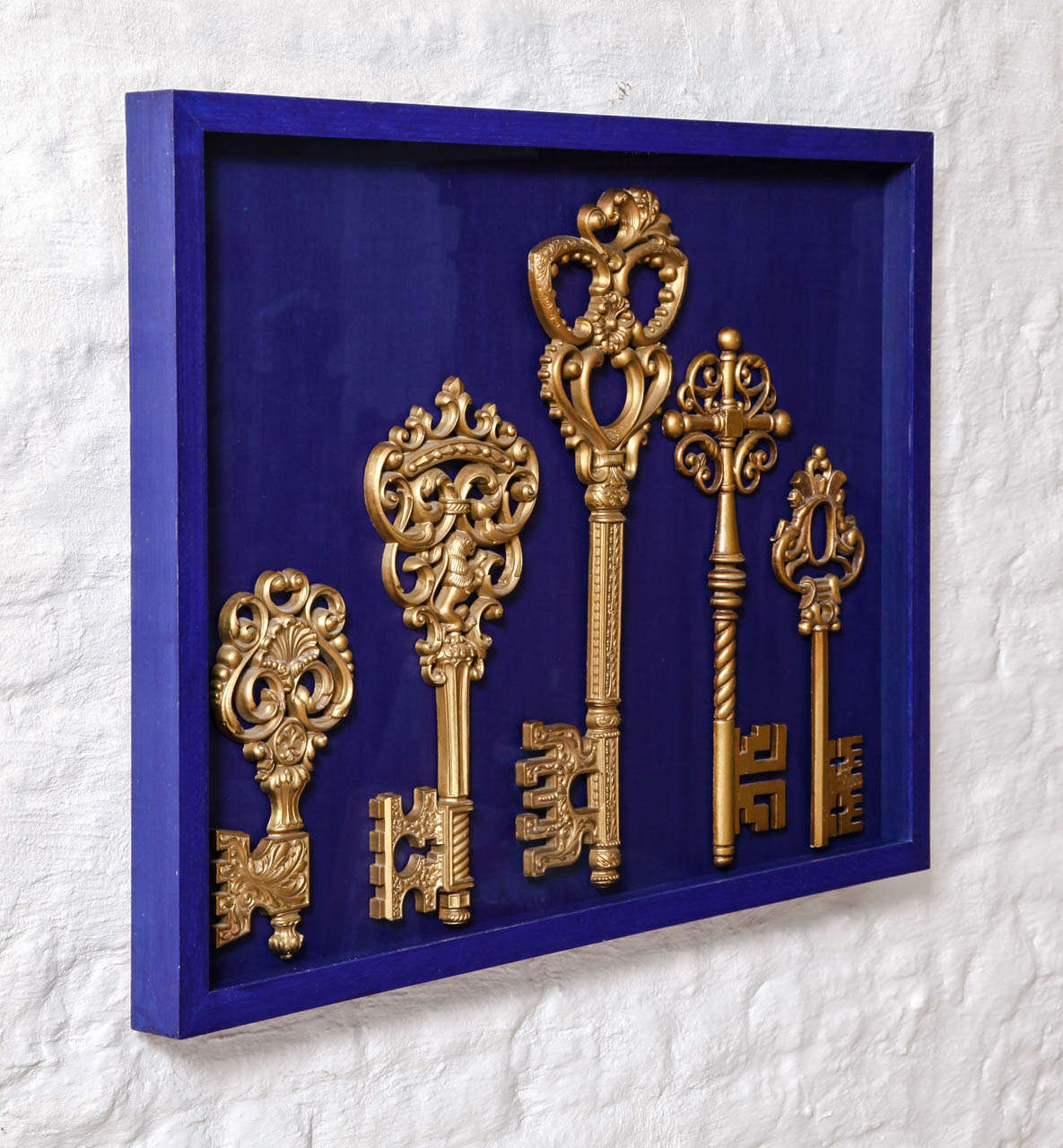 saint peter's keys of heaven,
set of five oversized metal and plastic gilded keys in a klein blue frame