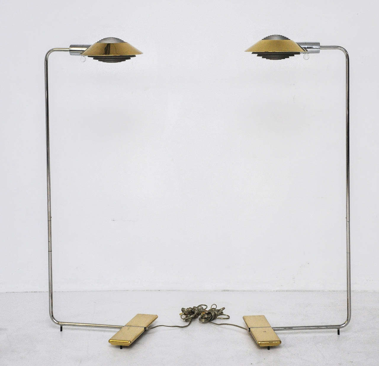 Pair of Cedric Hartman lamps in 2-tone brass and stainless steel.  Lamps are adjustable in height with swivel shades.