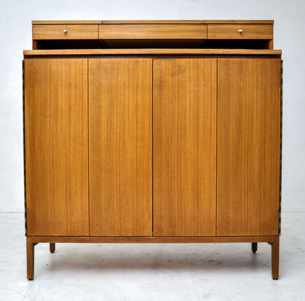 Paul McCobb gentleman's chest dresser. Calvin Series. Lift up mirrored section. Bi fold doors with fitted interior.