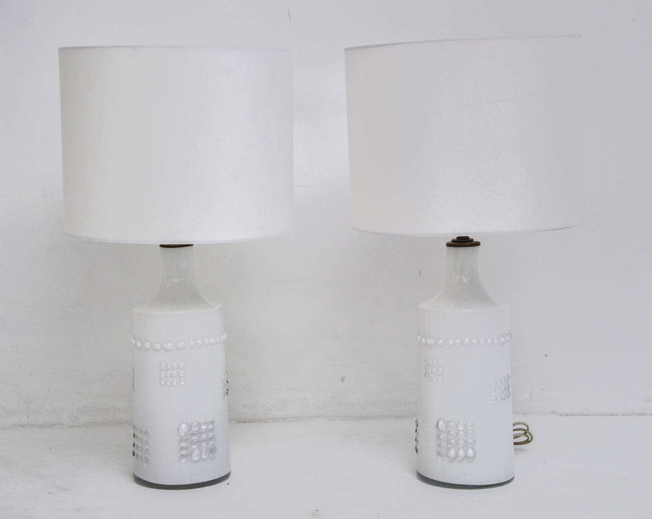 White glass cased in clear glass lamps. Made in Sweden, circa 1960s.