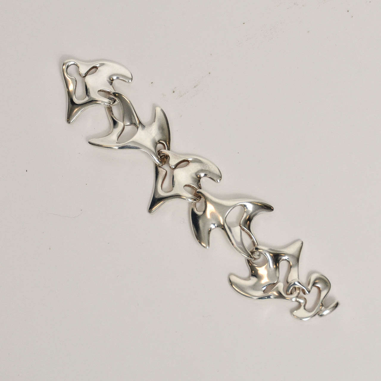 The Amoeba:  Fantastic Sculptural Links Designed by Henning Koppel for Georg Jensen in the late 1940's.  This (Design 89) is the more virile of his 2 biomorphic bracelet designs of the period.  It is evident that Koppel studied Sculpture.