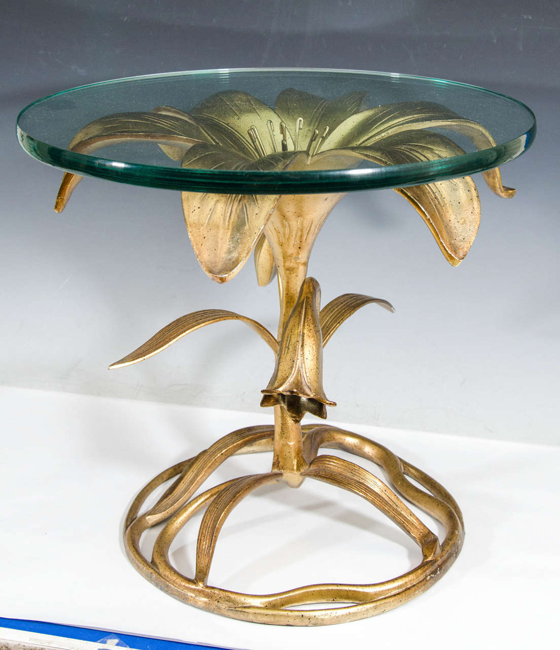 Fantastic pair of Arthur Court gilt aluminum flower form end or side tables in the shape of a Tiger Lily with beautiful thick round glass.Perfect compliment to any Modern Setting or Great Bedside Tables,with a striking Pair of Lamps upon Them.