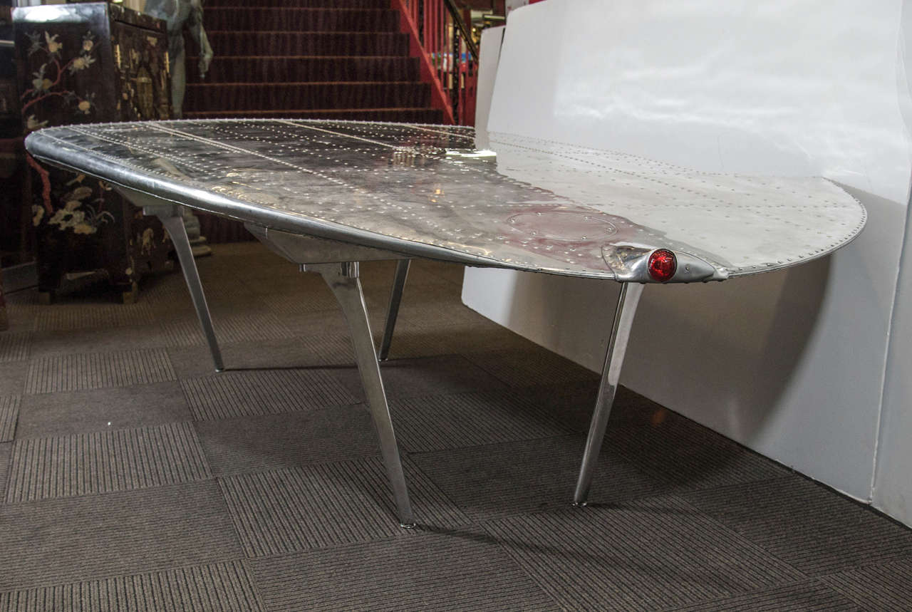 A vintage World War II Dakota DC-3 aircraft wing in riveted aluminum made into a table in the 1980s. Good vintage condition with age appropriate wear and patina.
