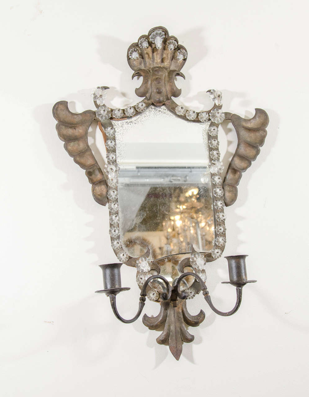An 18th century pair of Venetian mirrored and gilt hand-wrought iron candle sconces with rosettes. Good vintage condition with age appropriate wear and patina. Some silvering and one mirror has a crack. Never electrified.