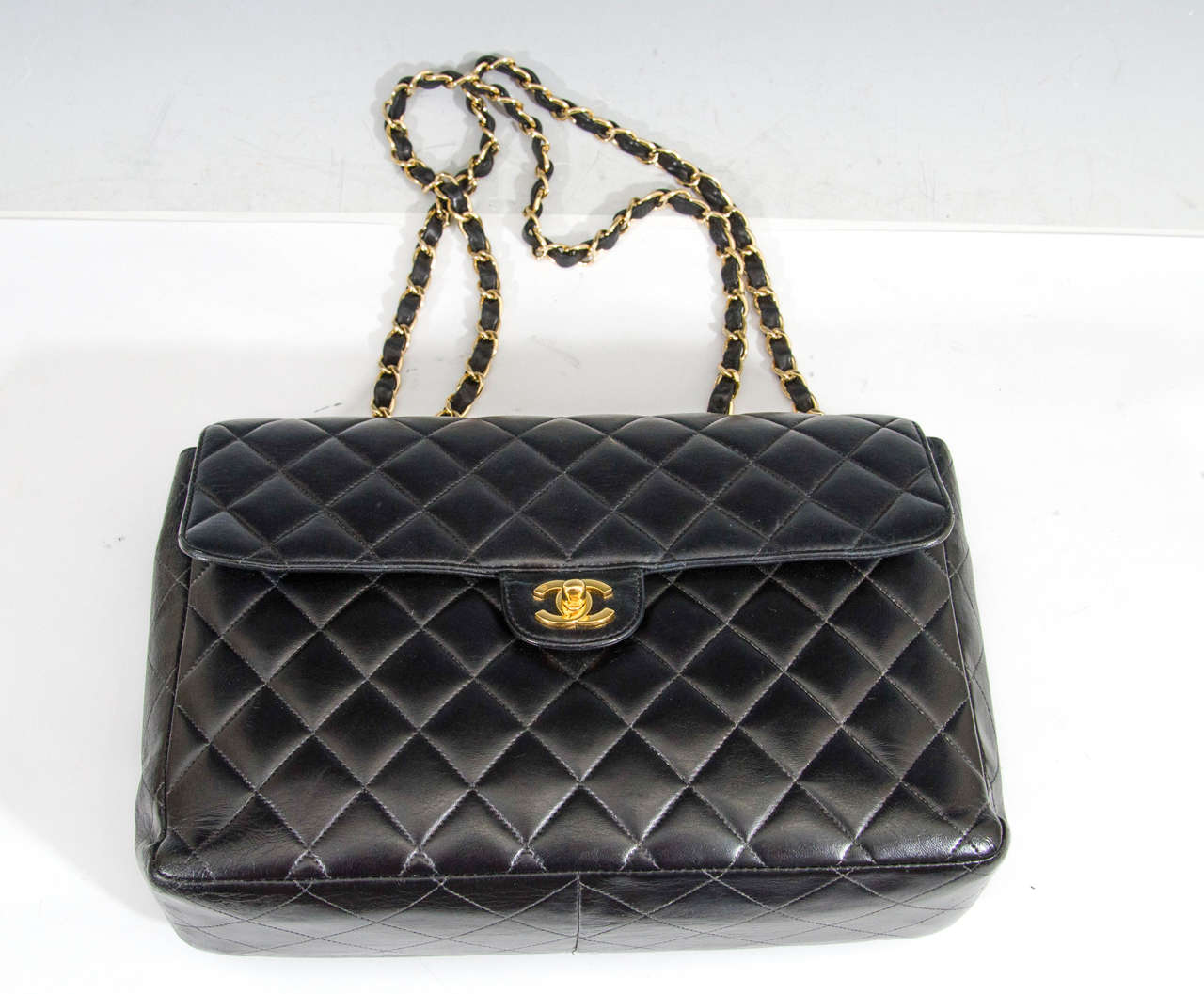 Cert. Authentic CHANEL Black Quilted Lambskin Maxi Classic Flap handbag with gold tone hardware. Authentication number, 5840064, permanently located inside of bag on CHANEL hologram label. Good vintage condition with age appropriate wear.

Item