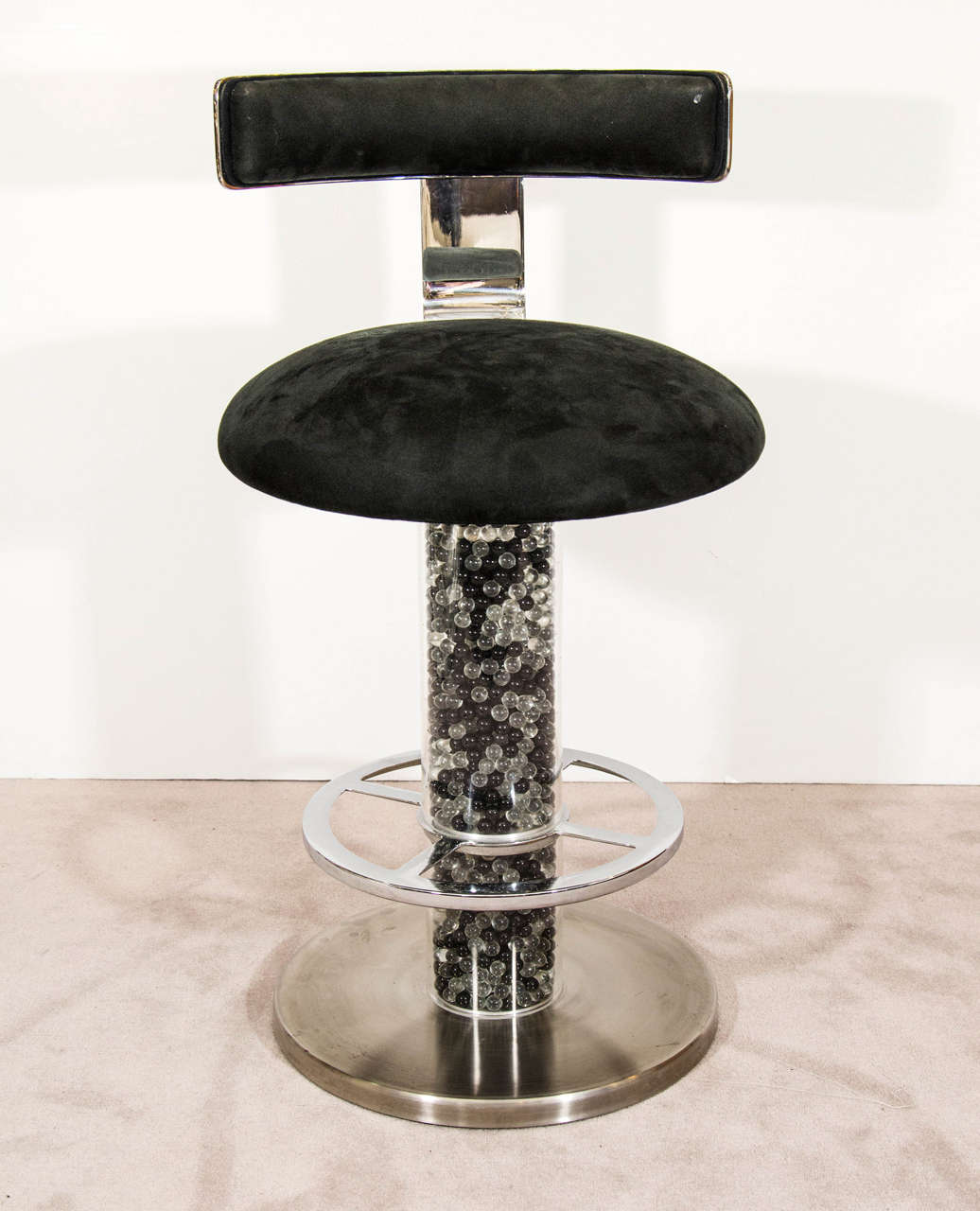 A vintage set of three black velvet swivel bar stools by Designs for Leisure circa 1980. Made of nickel with a column filled with black and white marbles. Good vintage condition with age appropriate wear. Some light scratches to one base.