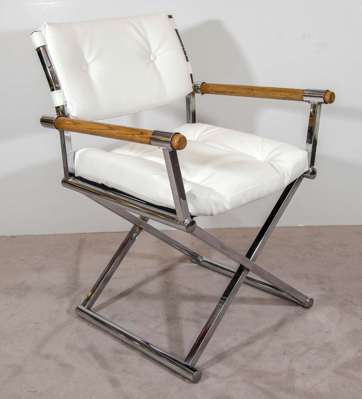 A vintage pair of director's chairs in white leather with a chrome x-base frame and wooden arm rests attributed to Milo Baughman.

Reduced from: $2,450