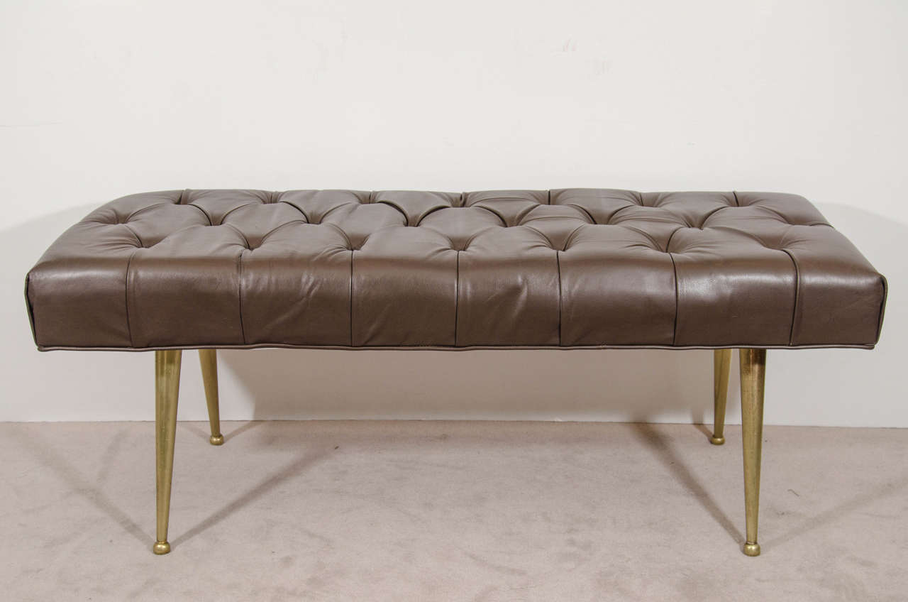 A vintage pair of Italian chocolate color button tufted leather benches with brass legs.  Good vintage condition with age appropriate wear and patina.  A few scuffs.