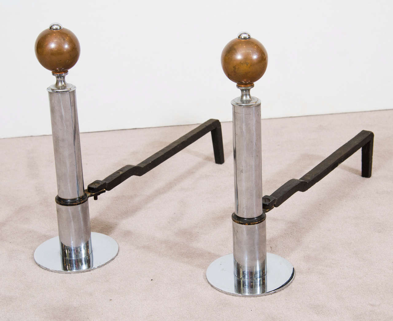 An art deco circa 1930s pair of andirons with chrome cylindrical body and copper ball finials. Good vintage condition with age appropriate wear and patina.

Reduced From: $1,000