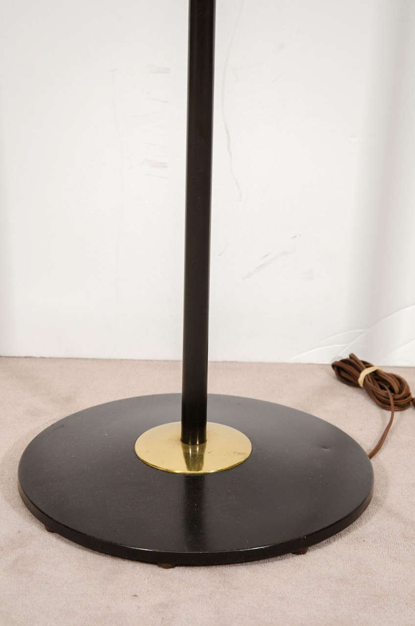 Stunning Gerald Thurston designed for Lightolier adjustable black enamel and brass floor lamp.  

Item available here online. By request, item can be made available by appointment to the Trade in New York.

