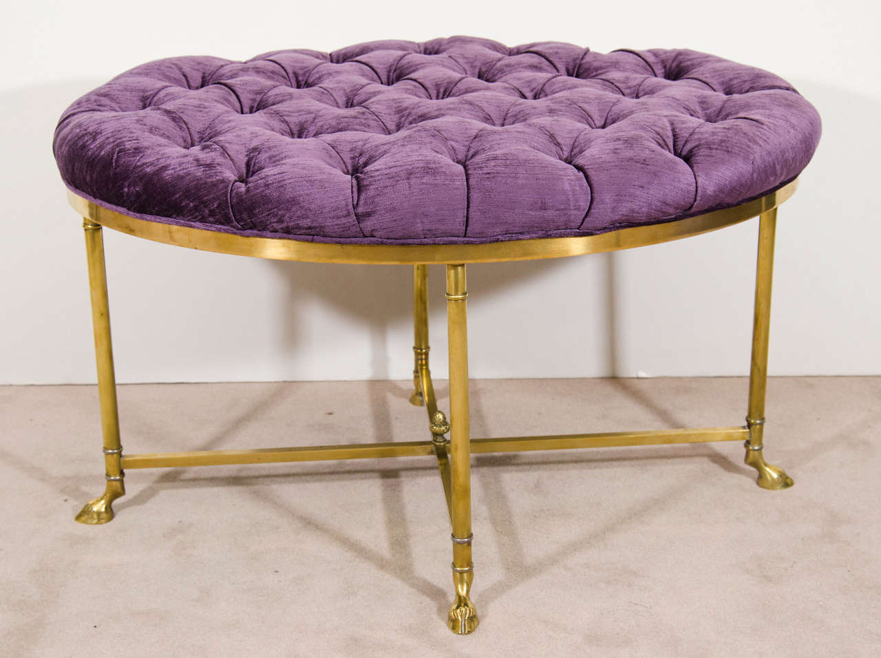 A vintage La Barge oval bench with purple button tufted velvet upholstery and brass hoof feet. Newly reupholstered.