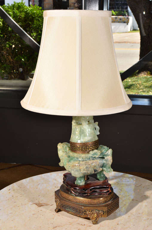 A heavily carved incense burner (Koro) of light green jade, mounted as lamp. Shade not included.