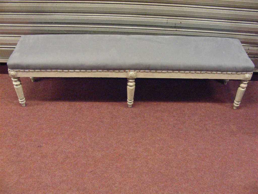 Mid-19th century neo-classical style bench, in gray patina wood, with new gray upholstery.