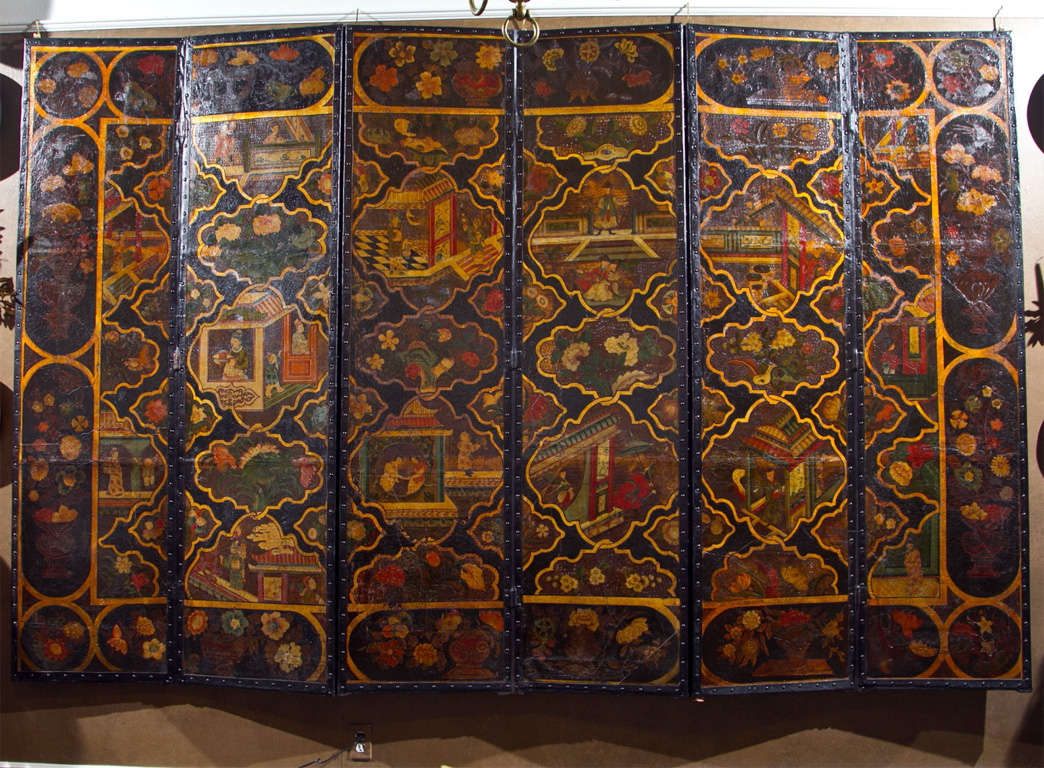 Chinoiserie painted leather six fold screen depicting painted panels of courtly ladies and gentlemen at various persuits with pagodas, pavillions and gardens within a border of floral sprays.