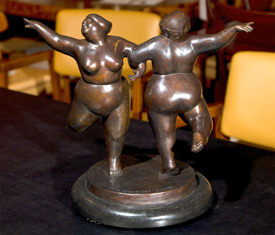 A pair of patinated bronze female dancers on a turning marble base by artist, B. Chen.  Signed 18/36,  1997.