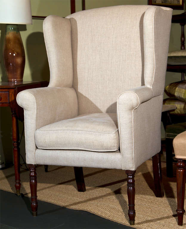 An English Regency wing back chair with turned legs.