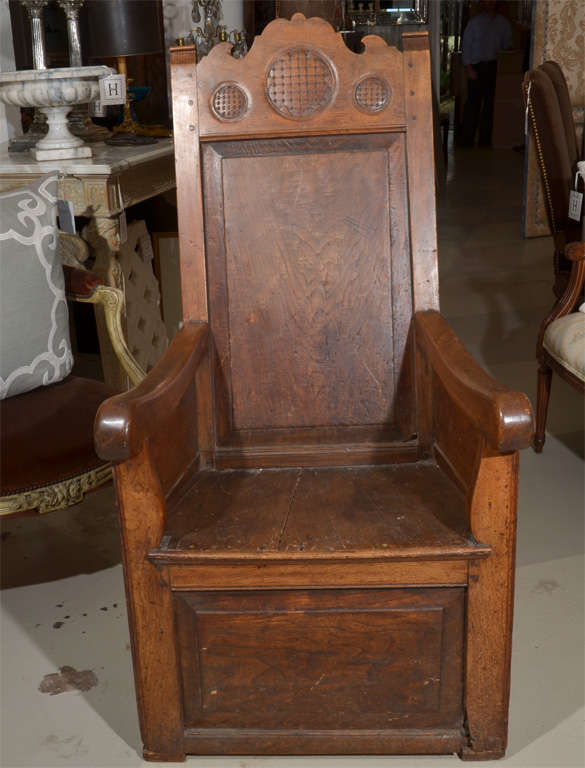 A Jacobean Revival Armchair,
carved crest over the plank back