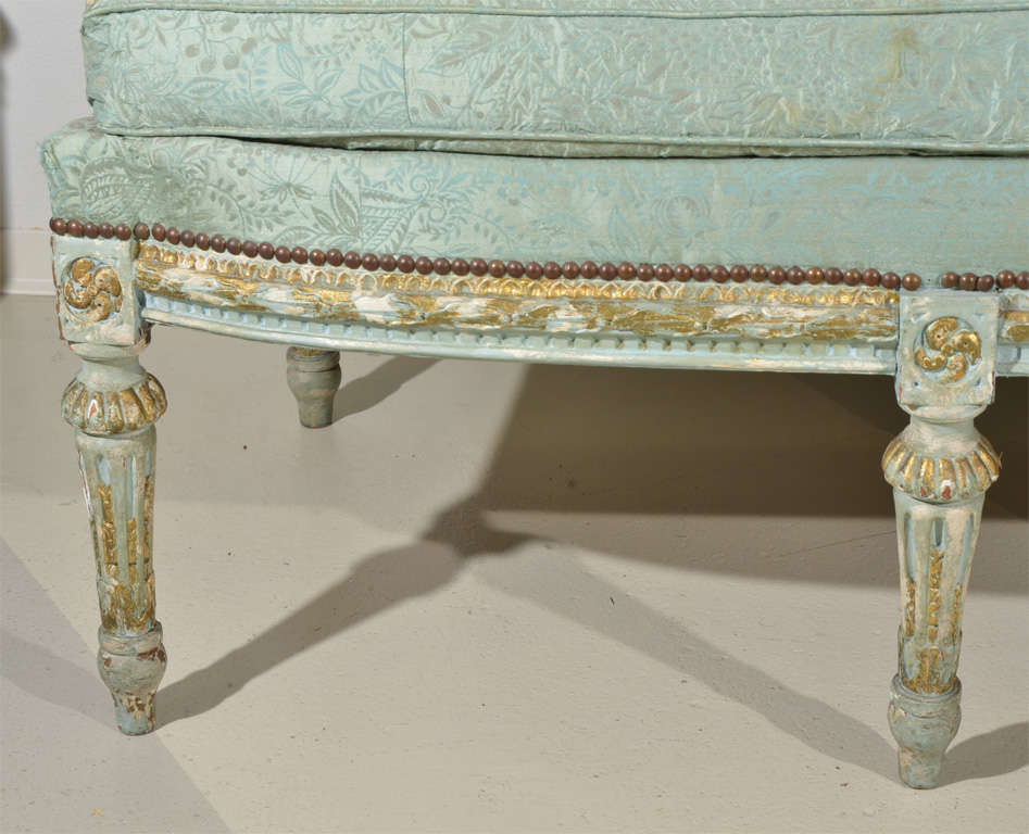 Louis XVI Style Painted and Parcel Gilt Canape,
with a stylized foliate carved frame,
raised on fluted tapering legs