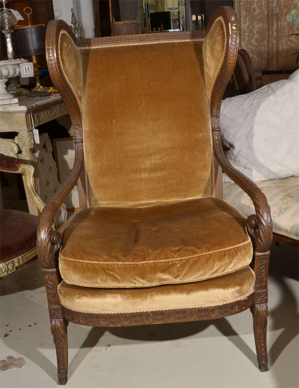 Wingback Fireside Chair, finely carved frame with scrolling arms, soft tan velvet upholstery