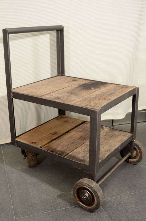 Industrial cart on wheels with double shelves. Made of reclaimed wood and steel. Makes a great side table, nightstand or additional storage accent.