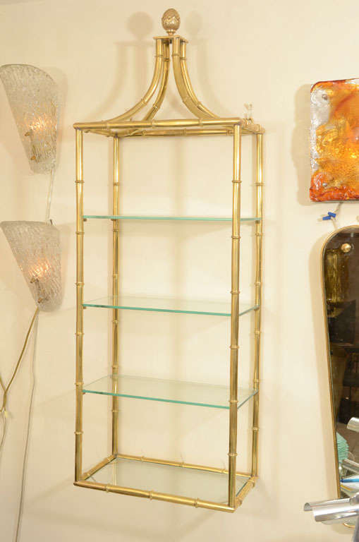 Brass faux bamboo four tier wall mounted shelving.

View our complete collection at www.johnsalibello.com