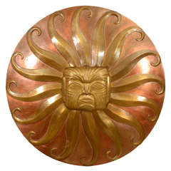 Patinated brass "sun face" motif wall applique