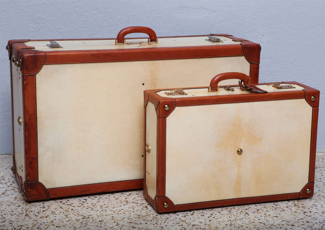 Fine leather-trimmed, vellum trunk and suitcase were made in Italy for famed New York leather goods purveyor, T. Anthony, circa 1960. Noted T. Anthony clients include Marilyn Monroe, Jackie Kennedy, and the Duke and Duchess of Windsor. Price is for