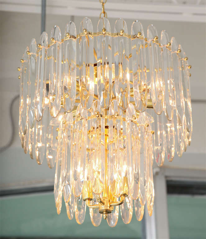 Gorgeous, two-tiered brass chandelier by Gaetano Sciolari features his signature flat, 